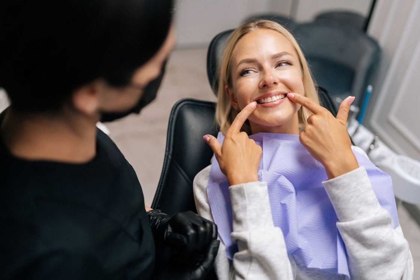 A dentist and a smiling patient in a clinic