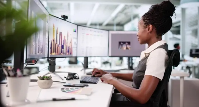 Analyst reviewing charts on screens