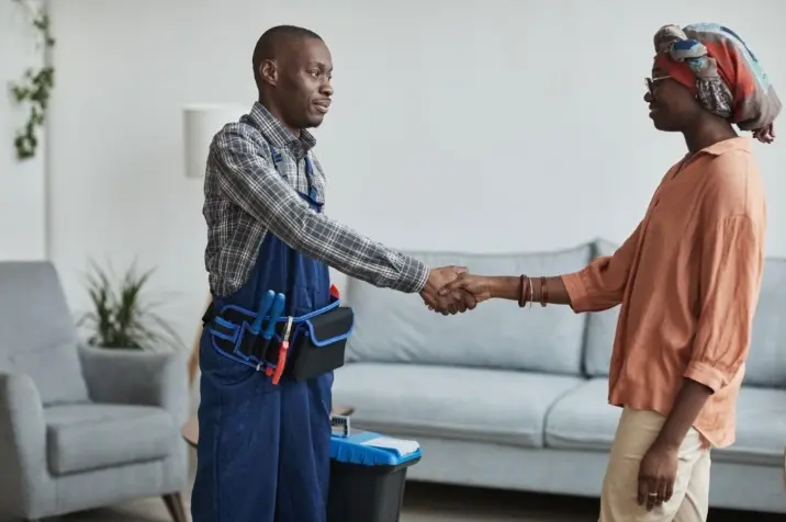 Customer and craftsman shaking hands