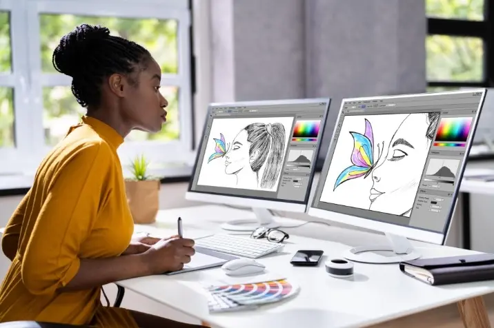Illustrator working on two screens