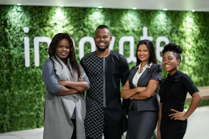 Team in front of a green wall